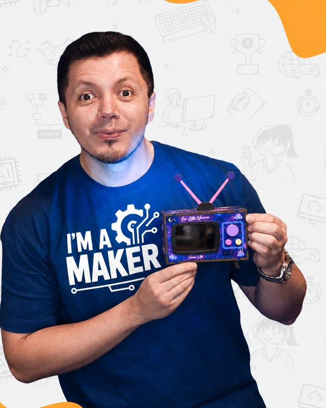 The maker behind Watch N Wow in an I'm a Maker T-shirt, holding an Our Little Universe Mini TV