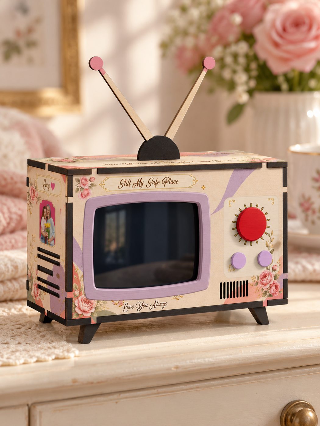 Close-up of a Vintage Roses Mini TV with its painted red knob